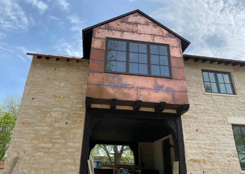 Copper metal panel facade on a stone building for Metal Roof Coating in Gaines