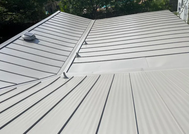 Solar attic fan installed on a metal roof for Roof Ventilation in Gaines